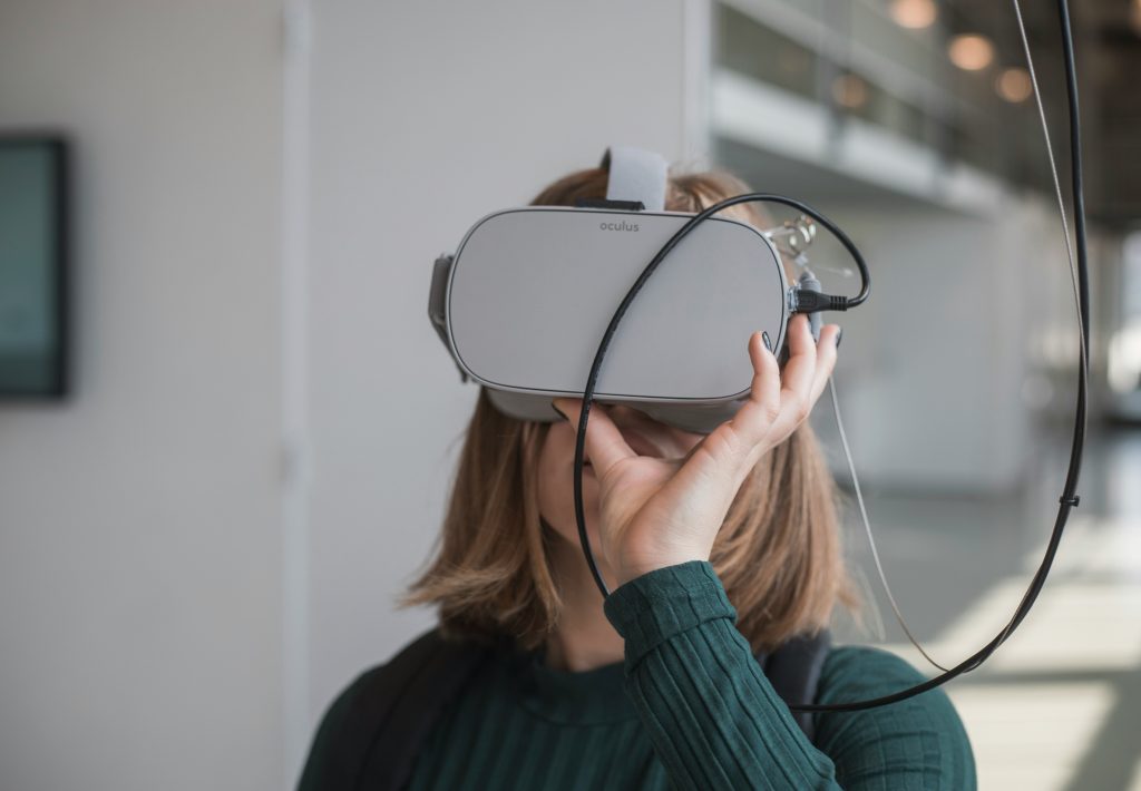 woman holding black vr google